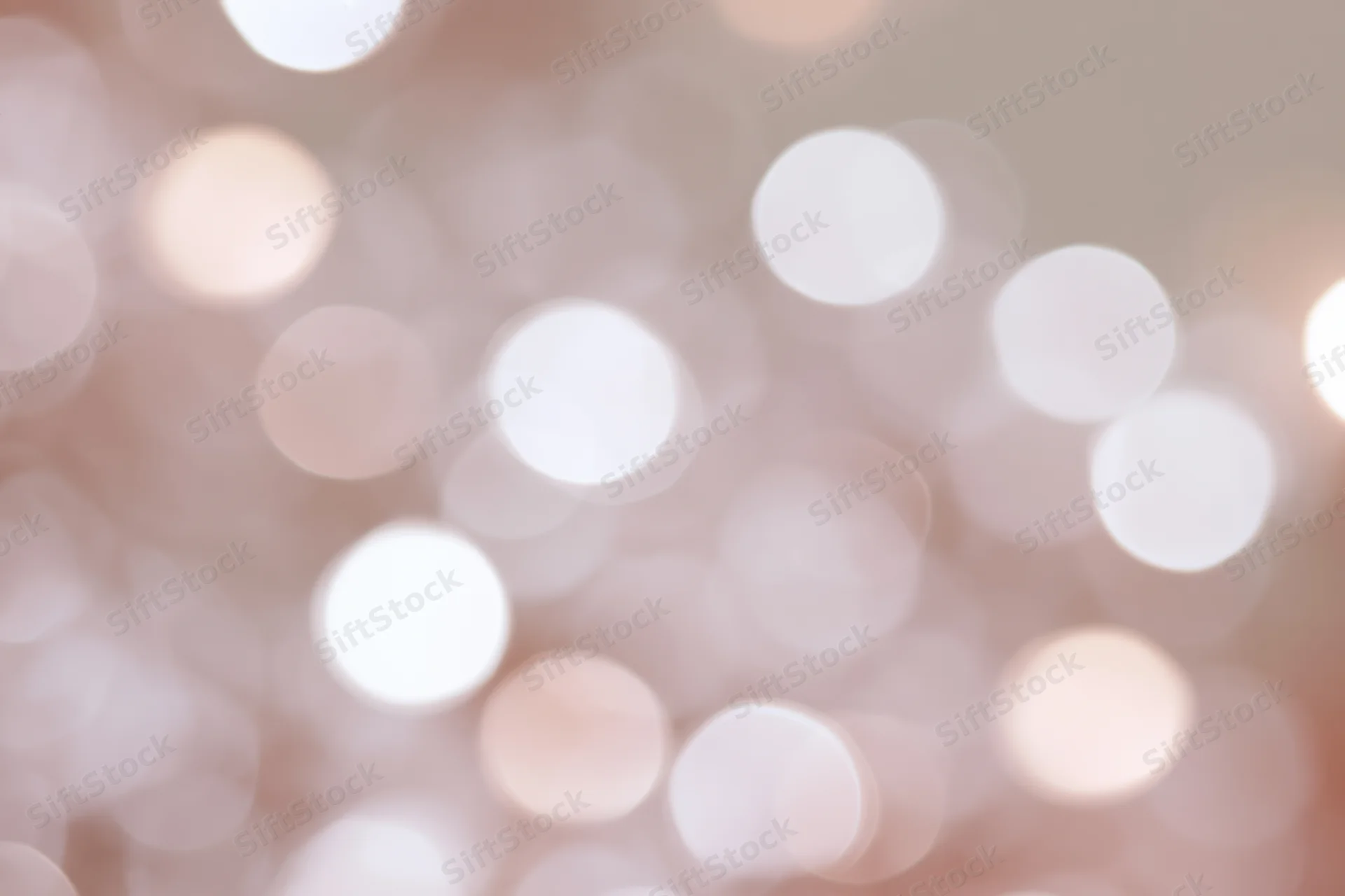 Soft out-of-focus white and pale pink bokeh lights forming a blurred background