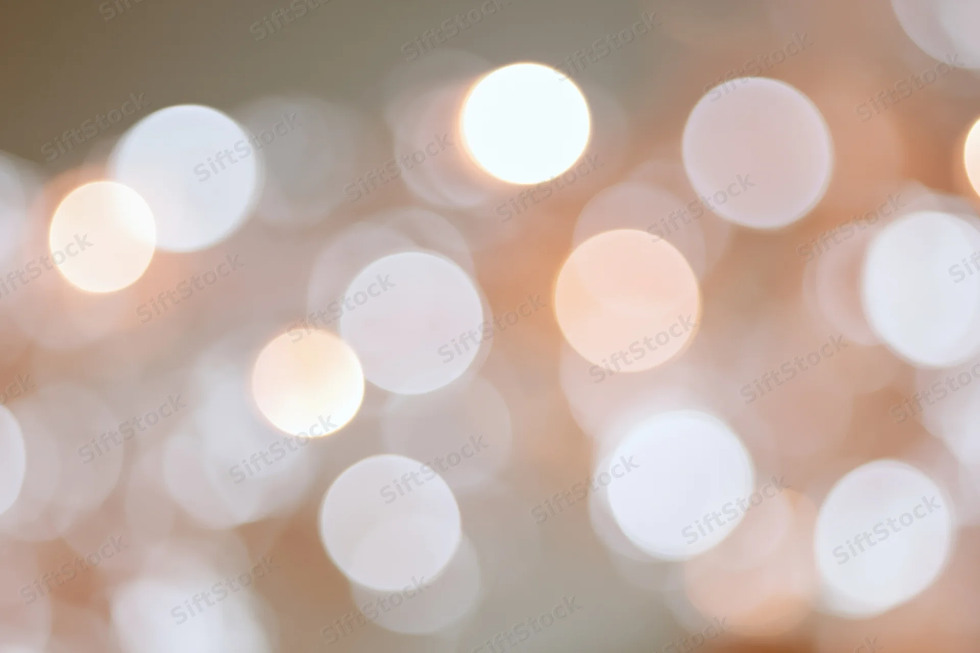 Soft out-of-focus white and pale pink lights arranged as a bokeh background