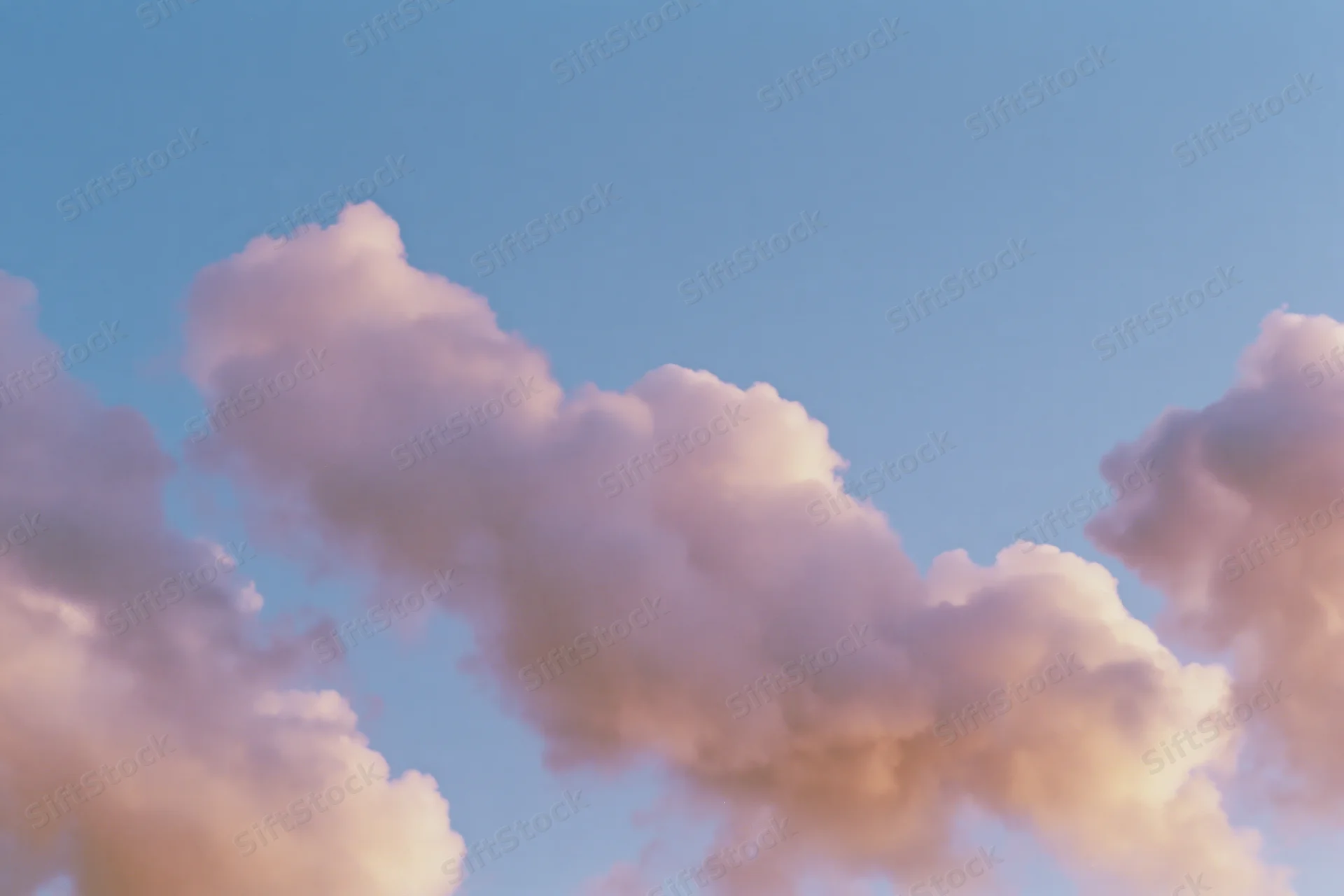 Soft cumulus clouds drifting across an open daytime sky