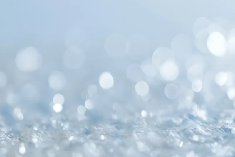 Soft out-of-focus abstract background with scattered circular light reflections and glittery texture