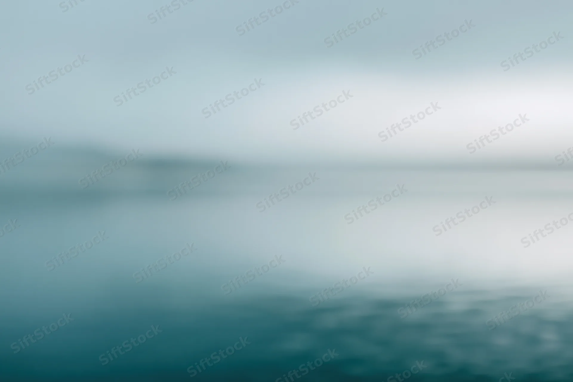 Soft blurred gradient of blue and teal tones with no distinct subject or object
