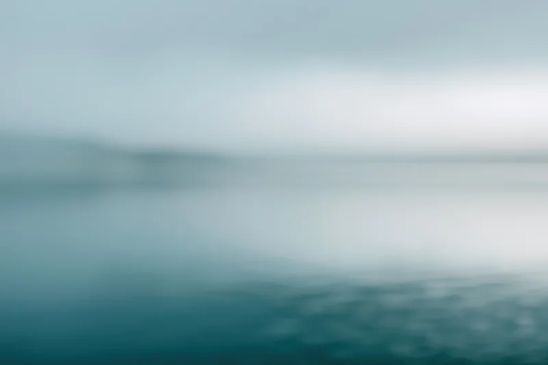 Soft blurred gradient of blue and teal tones with no distinct subject or object