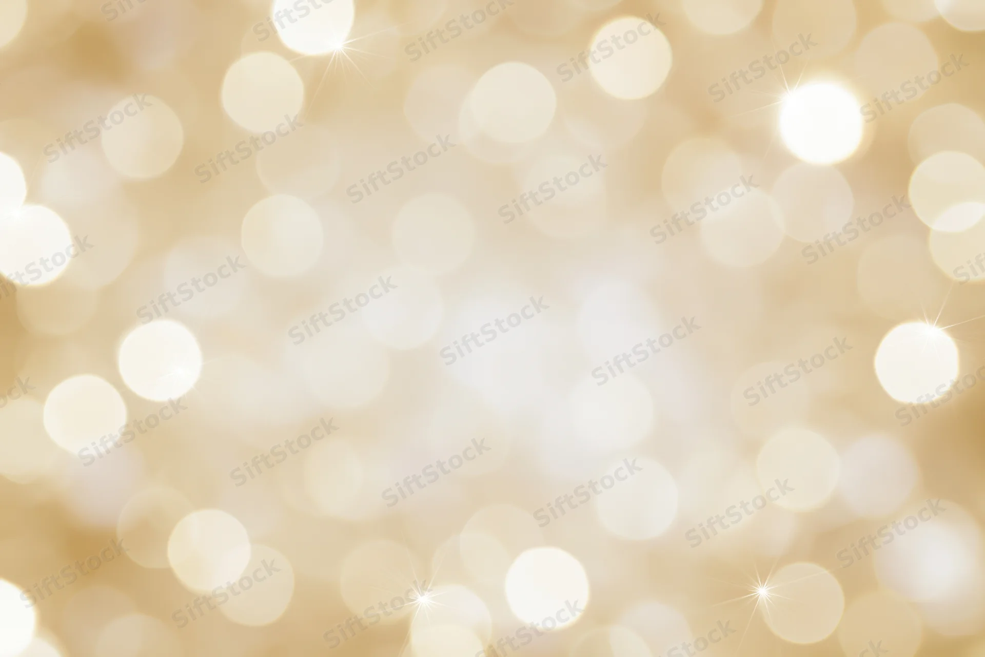 Soft golden bokeh lights scattered across a blurred background with copyspace in the center