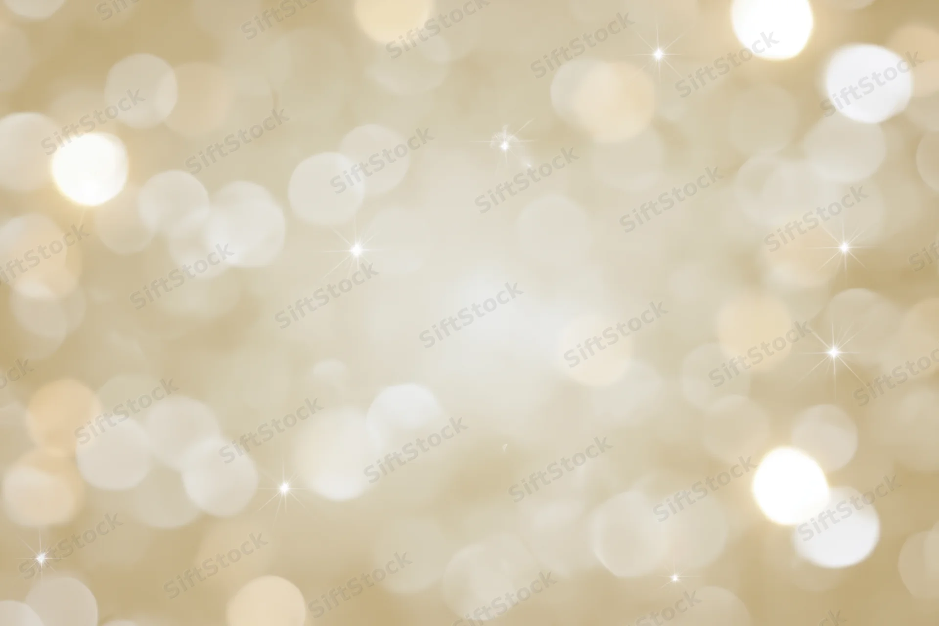 Soft out-of-focus bokeh background with scattered circular lights and sparkles in warm golden tones