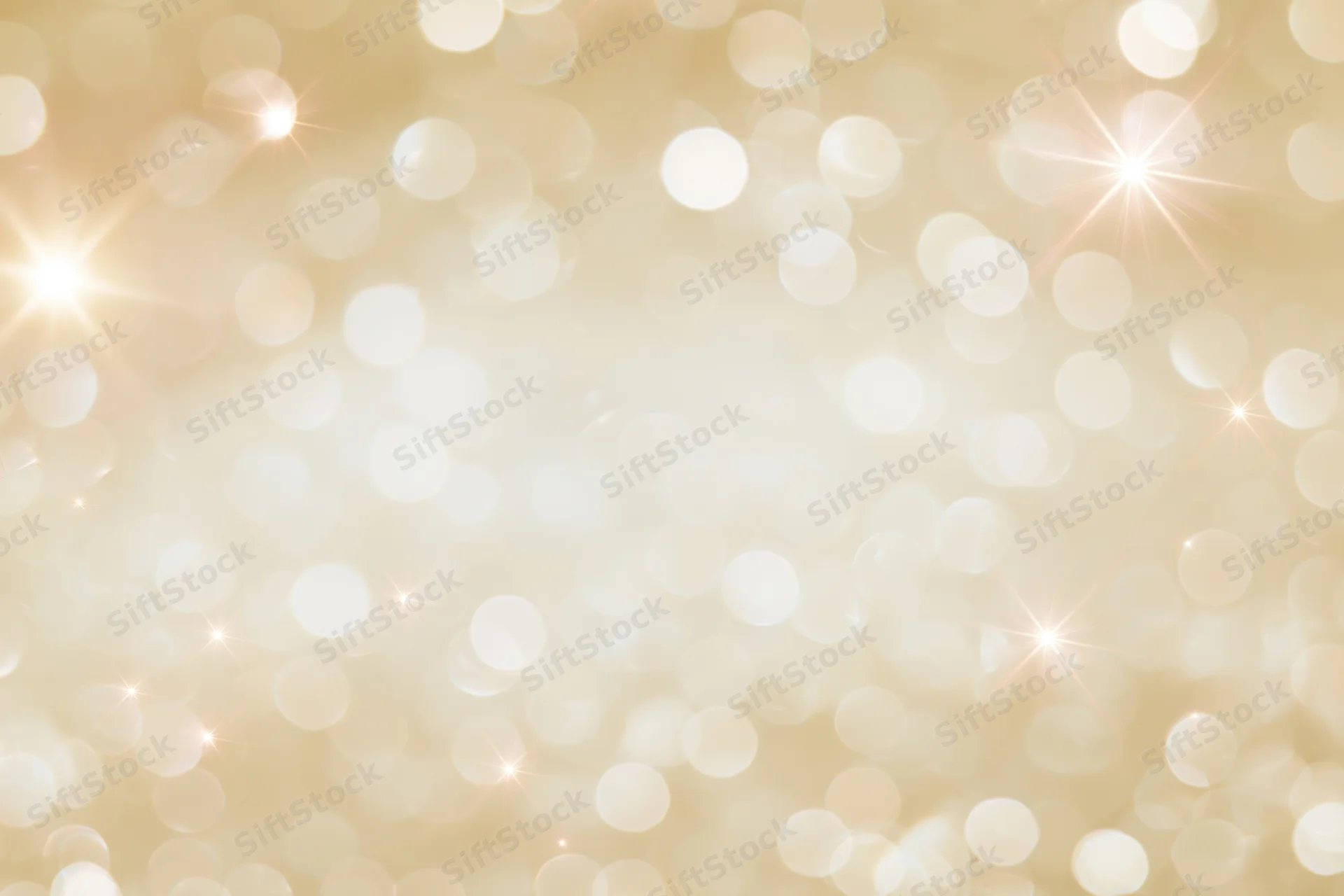 Soft golden bokeh background with scattered circular lights and starbursts, creating a festive glow