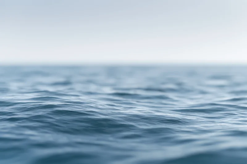 Blurred ocean surface with gentle ripples viewed from water level