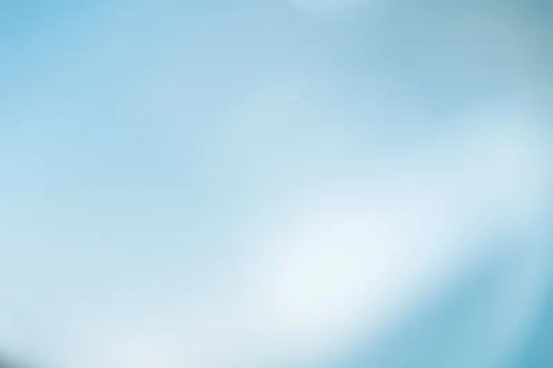 Soft blurred pale blue sky with diffused light and subtle gradient as background