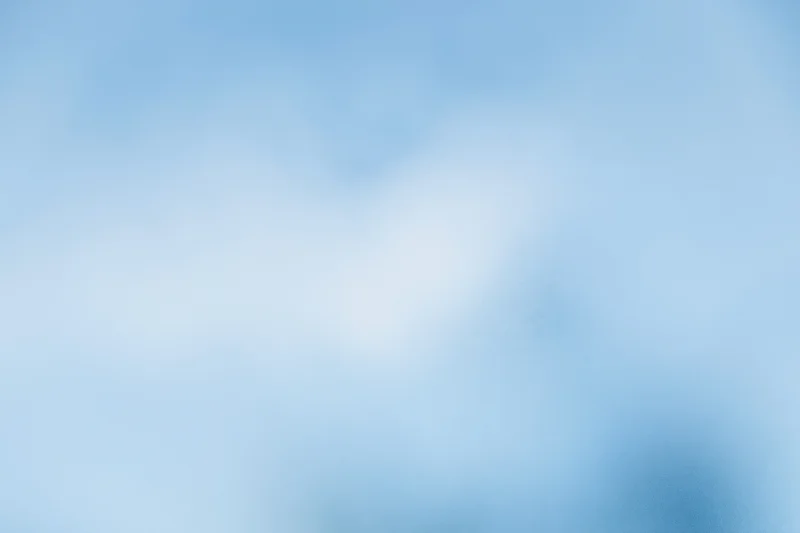 Soft blurred pale blue sky with frosted glass texture as background
