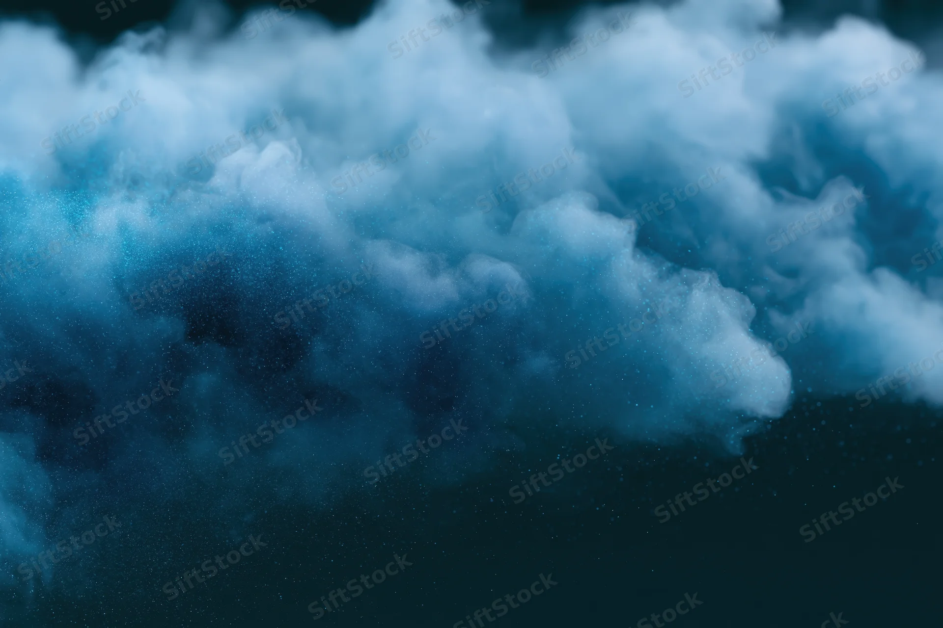 Swirling blue luminescent smoke dispersing mid-air against dark background