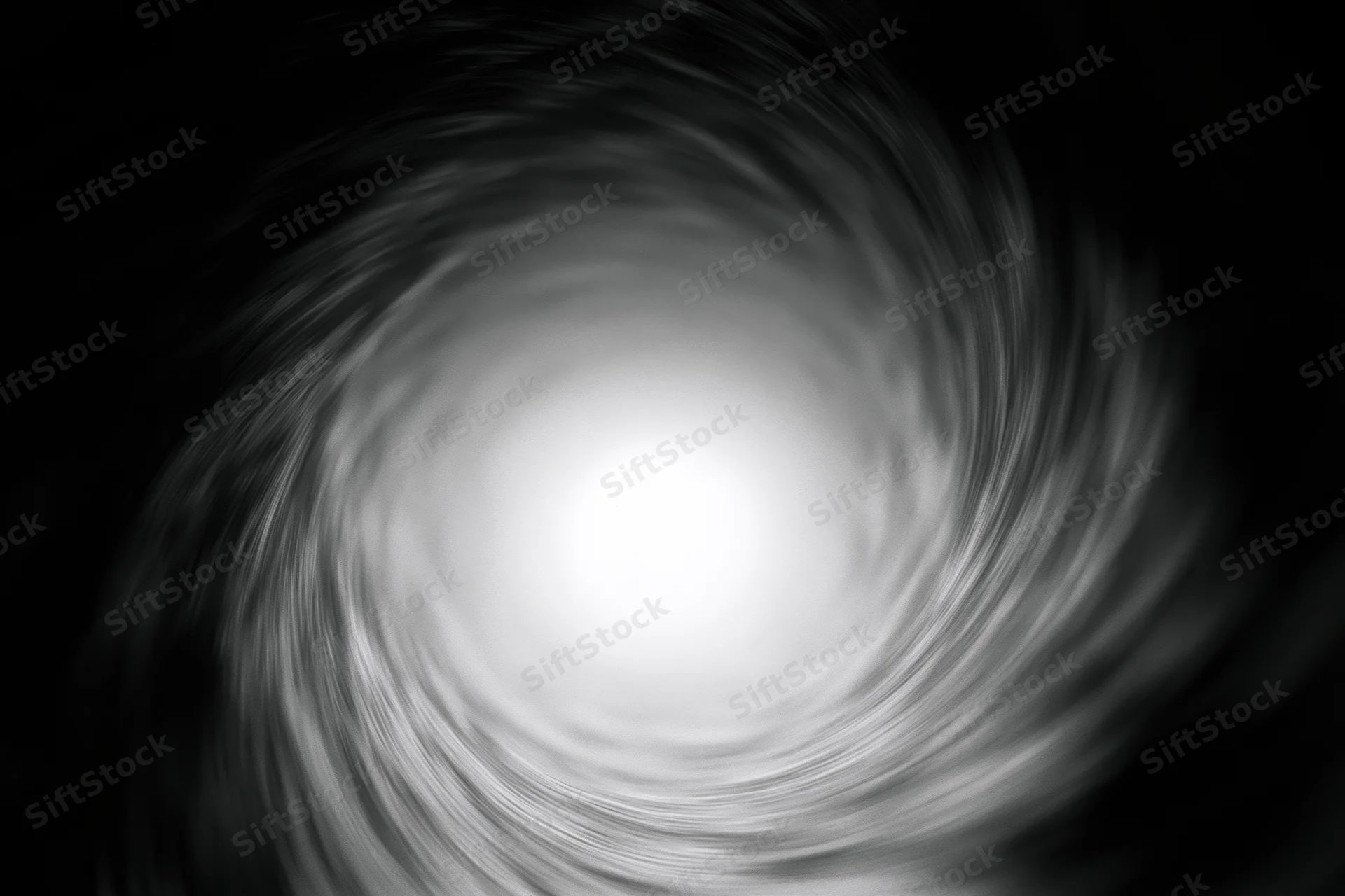 View from inside a dark circular tunnel looking toward a bright light at the center