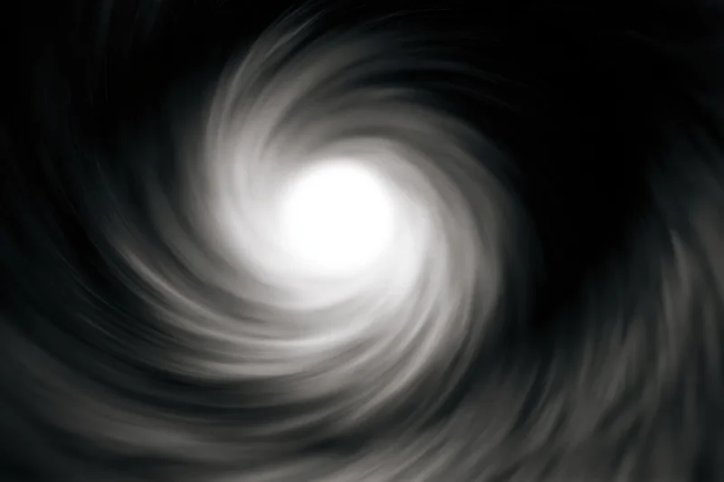 View from inside a dark circular tunnel looking toward a bright light at the center