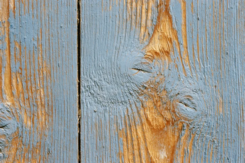 Weathered wooden plank surface filling the frame with visible grain and knots