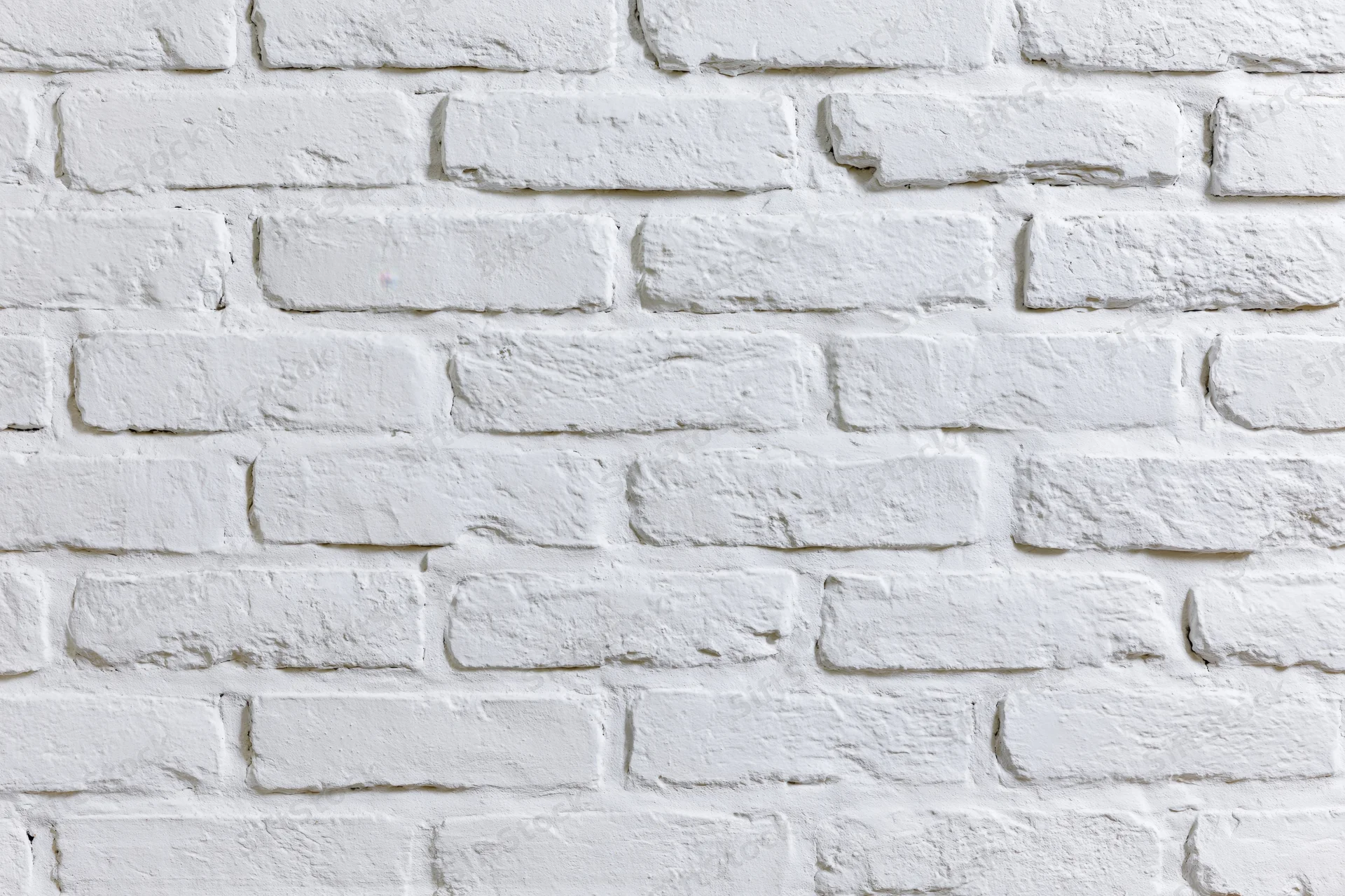 White-painted brick wall filling the frame as a textured background