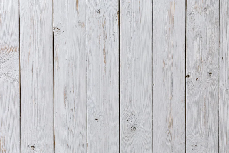 White-painted wooden planks arranged vertically filling the frame