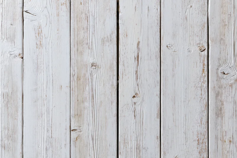 White-painted wooden planks arranged vertically filling the frame