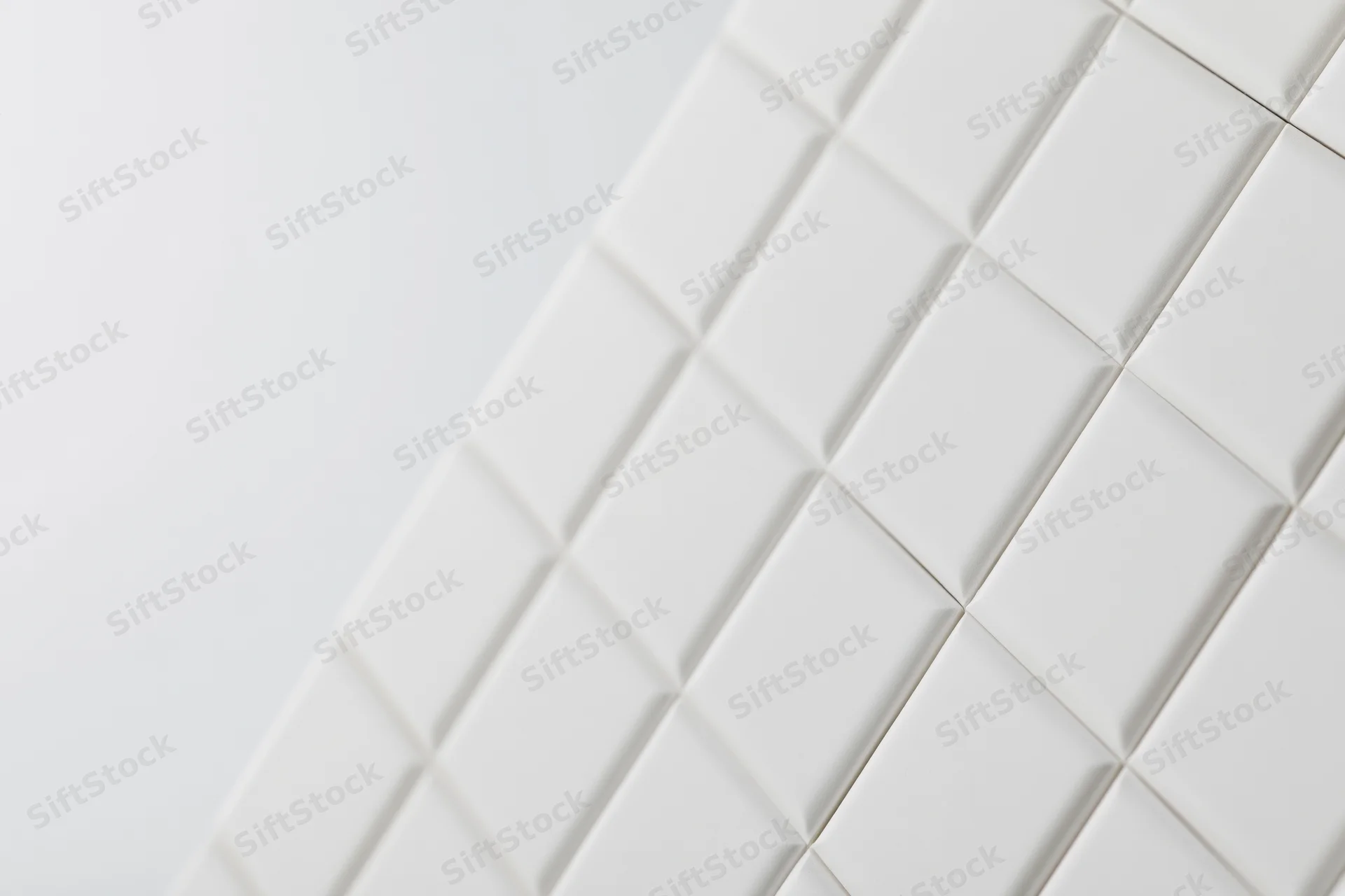 White square tiles arranged diagonally on a smooth surface