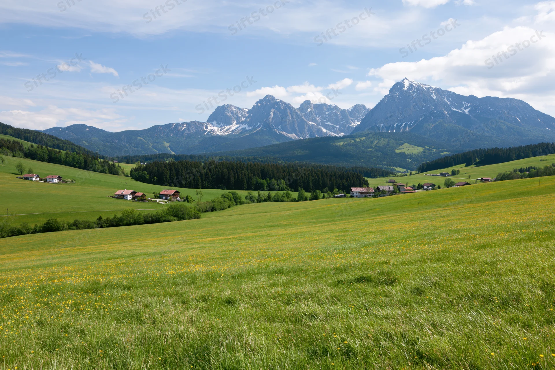 Rolling green meadows with scattered farmhouses and snow-capped alpine mountains in the background