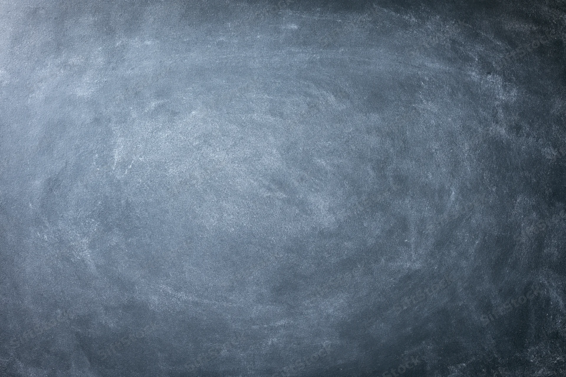 Worn chalkboard surface filling the frame with smudged residue and texture