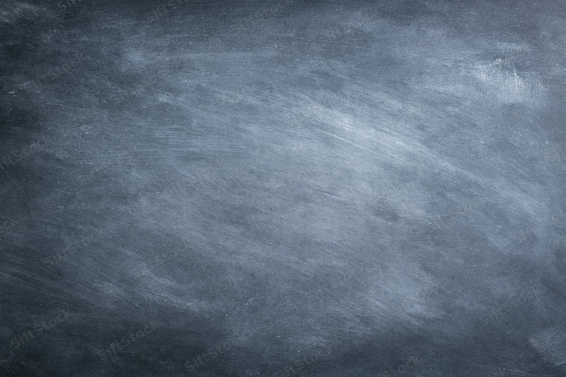 Worn chalkboard surface filling the frame with smudged chalk residue and textured grain