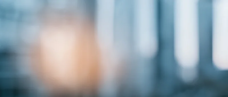 Blurred abstract light pattern with warm and cool tones creating a soft glowing background