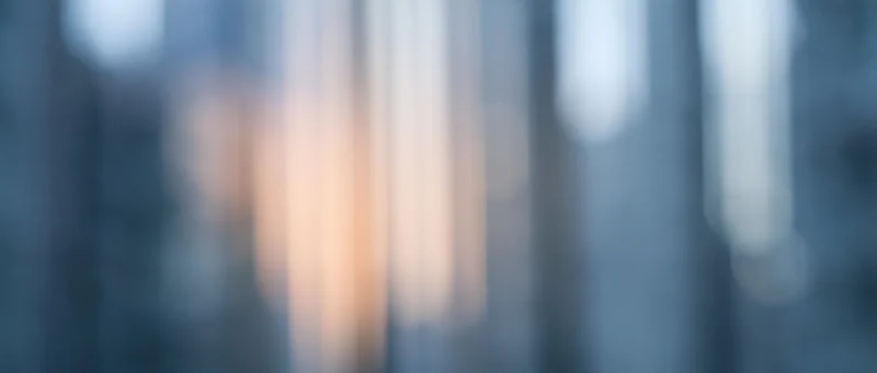 Blurred vertical light streaks in soft focus with warm and cool tones creating an abstract background