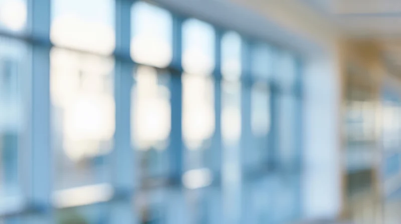 Blurred interior of a modern office building with glass windows and soft light