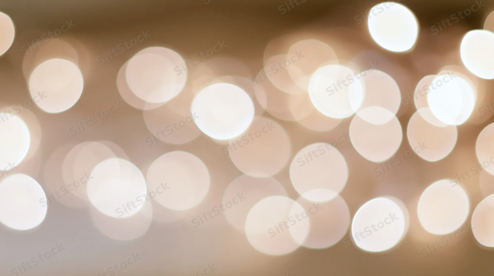 Blurred circular lights arranged in a warm glowing pattern across the frame
