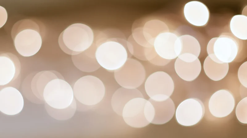 Blurred circular lights arranged in a warm glowing pattern across the frame