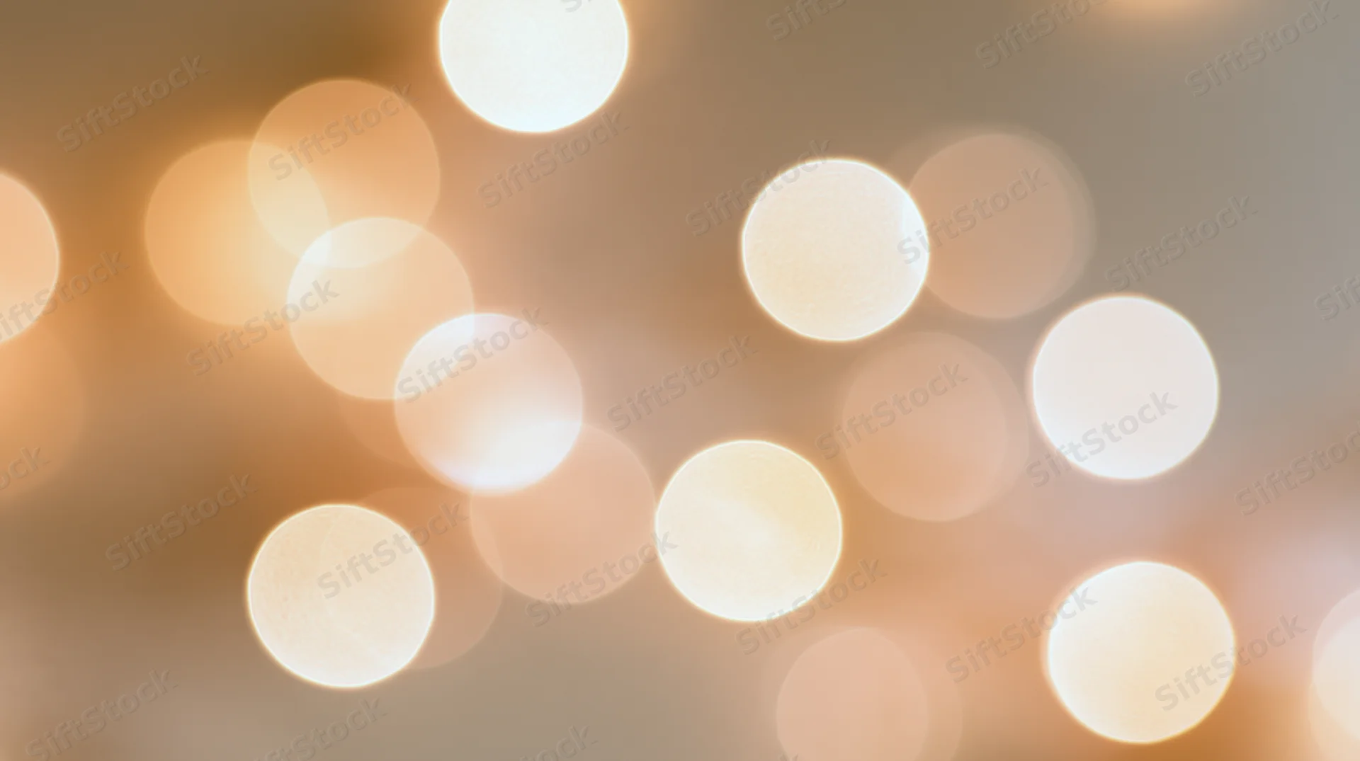 Blurred circular lights creating a warm glowing background for festive decoration