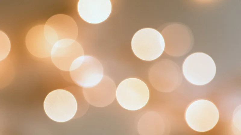 Blurred circular lights creating a warm glowing background for festive decoration