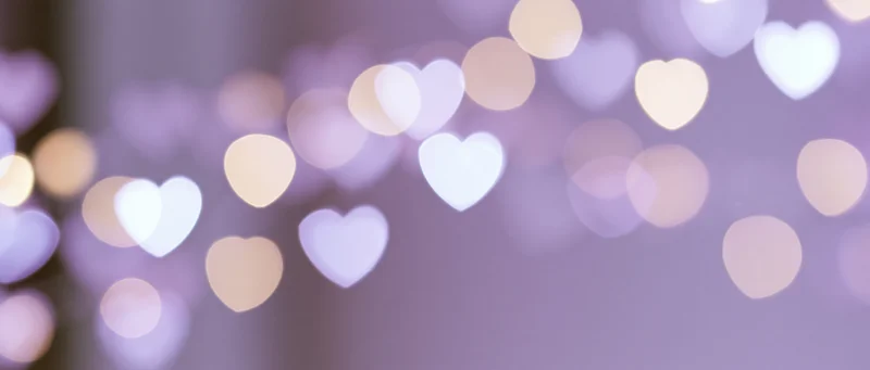 Blurred heart-shaped lights in soft pastel hues creating a romantic ambiance