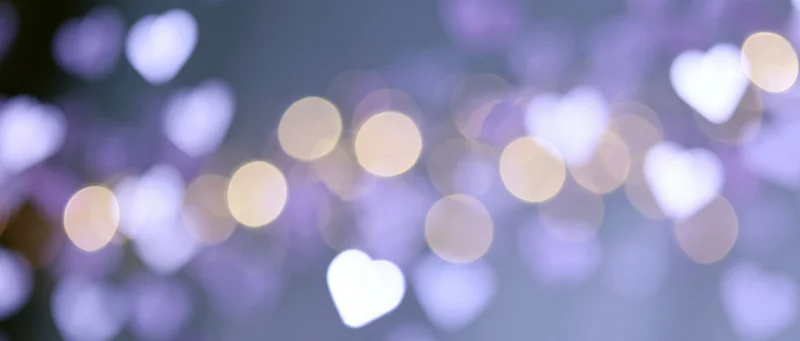 Blurred heart-shaped lights glowing softly in a romantic bokeh background