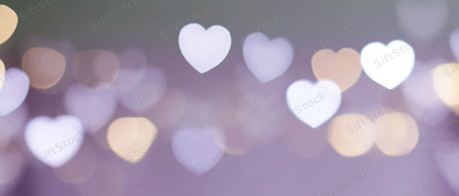 Blurred heart-shaped lights in soft pastel colors creating a romantic ambiance