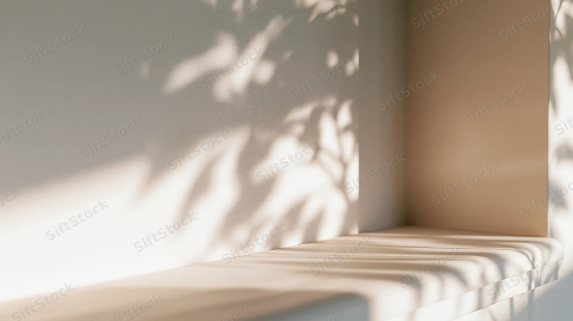 Sunlight casting leaf shadows on a white wall and shelf in a minimalist interior corner