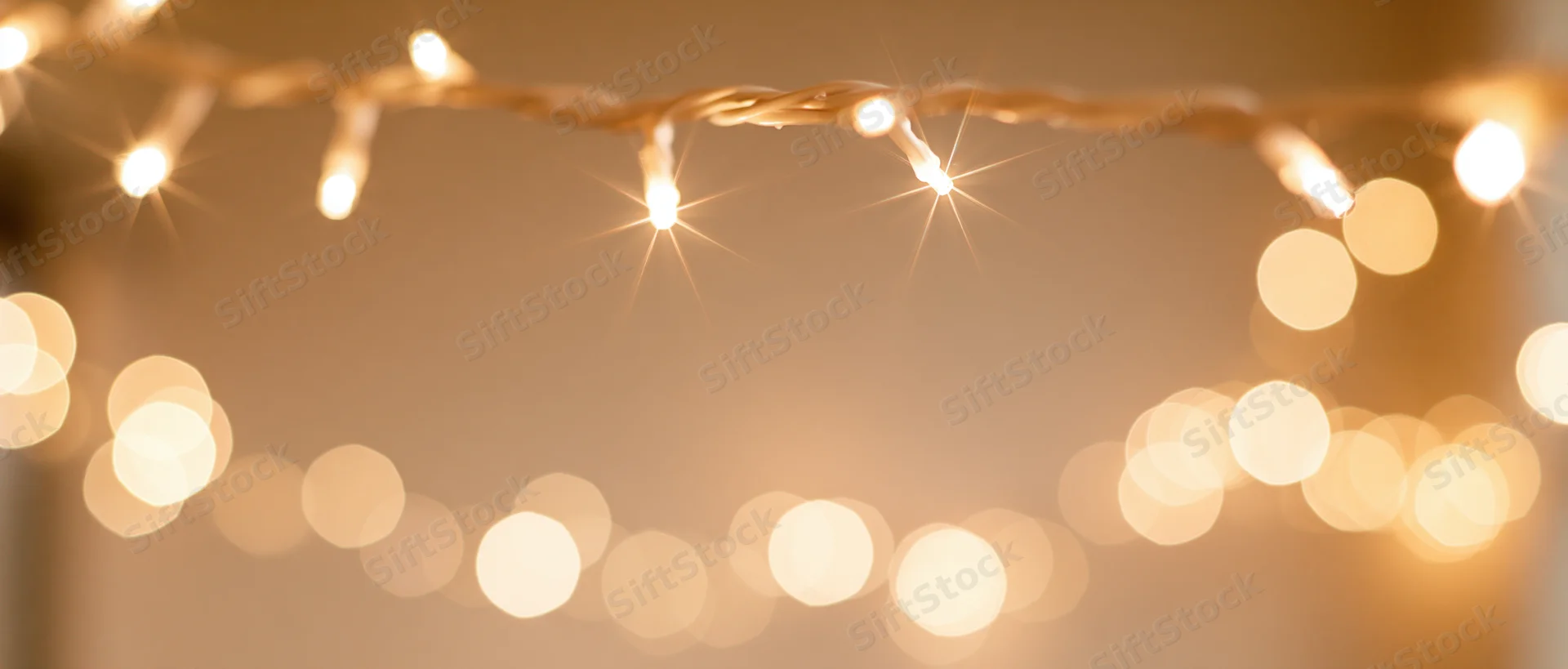 String lights glowing warmly in soft focus with bokeh effect