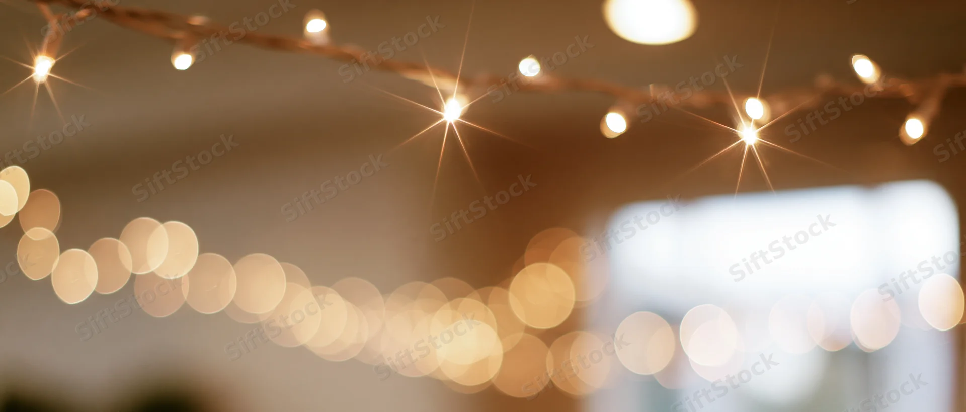 String lights glowing softly in an indoor setting with blurred bokeh background