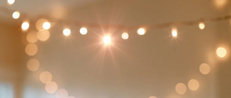String lights hanging from ceiling creating warm bokeh glow indoors