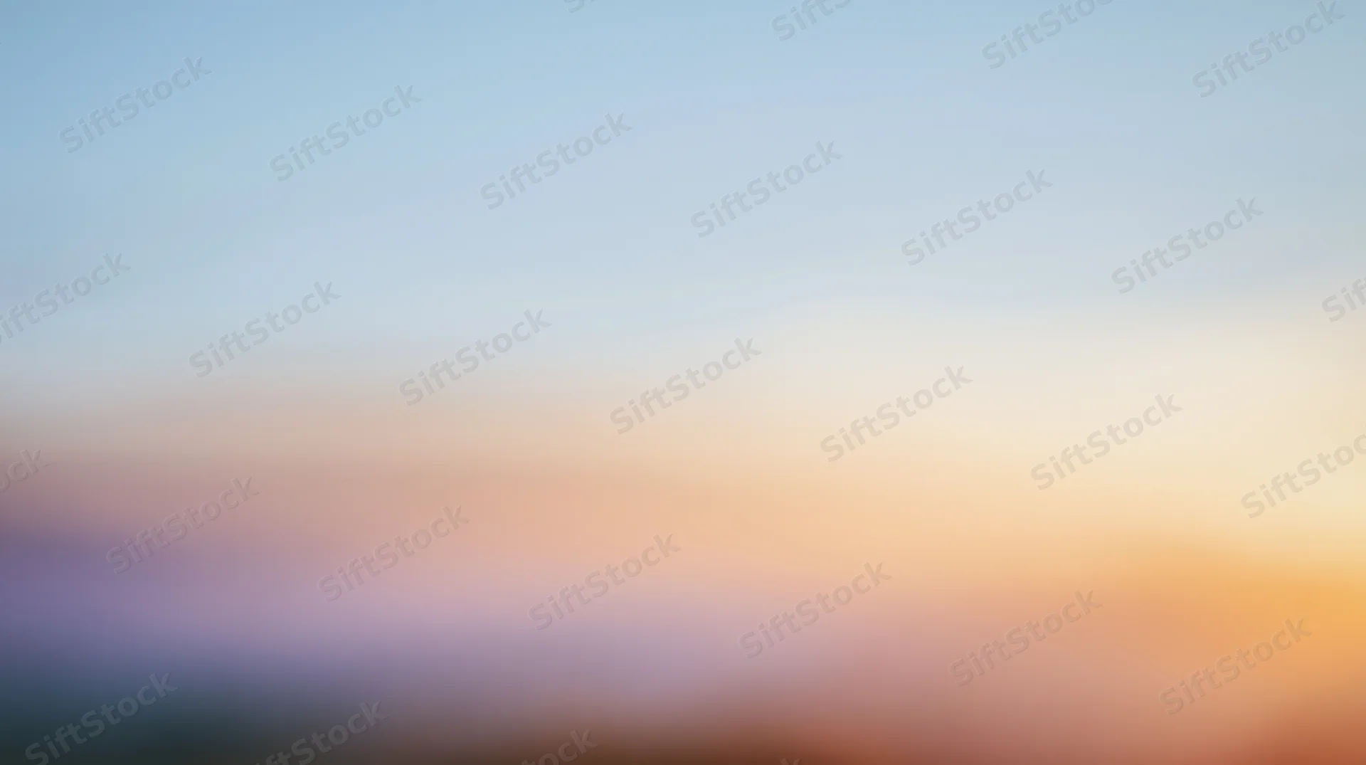 Soft gradient sky at dusk with warm orange and cool blue tones transitioning across the horizon