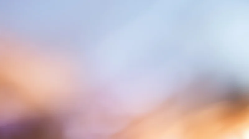 Soft blurred light gradient with warm and cool tones transitioning across the frame