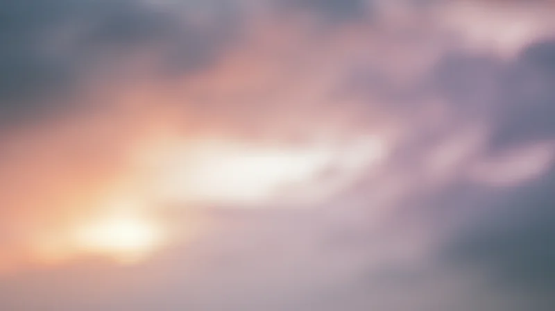 Soft blurred sky at sunset with orange pink and purple clouds filling the frame