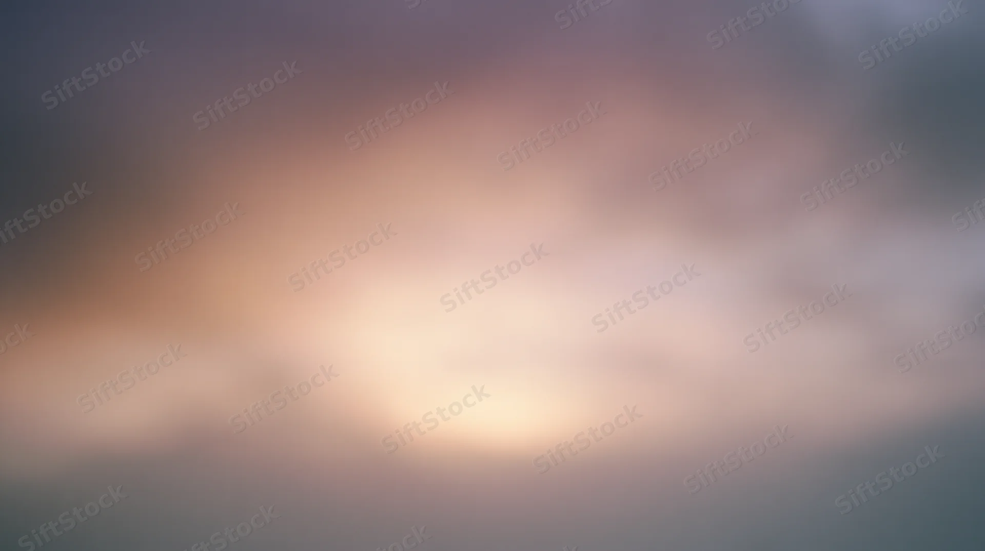 Soft glowing sky at twilight with hazy clouds and warm light gradient