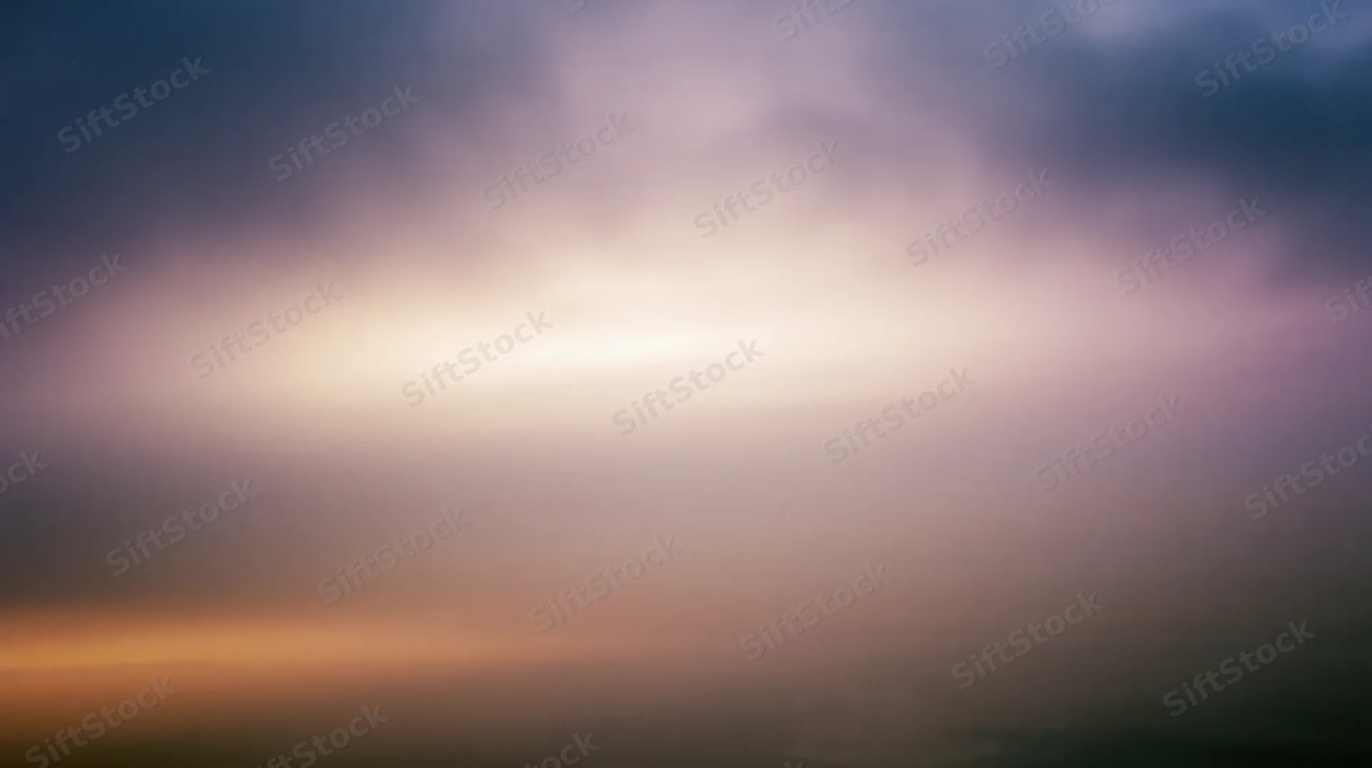 Soft pastel sky at twilight with layered clouds and gradient hues from horizon to upper atmosphere