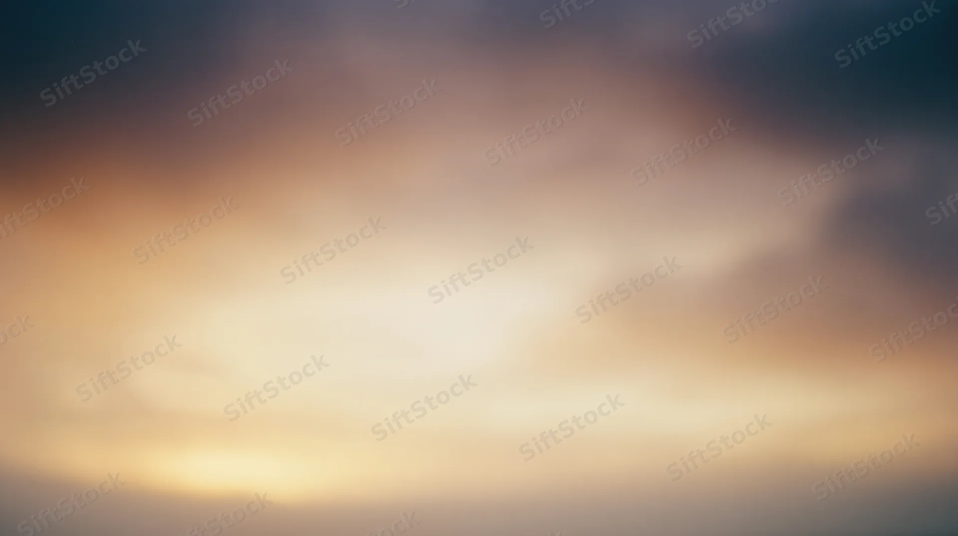 Soft blurred sky at sunset with warm and cool color gradient across the horizon
