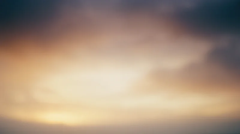 Soft blurred sky at sunset with warm and cool color gradient across the horizon
