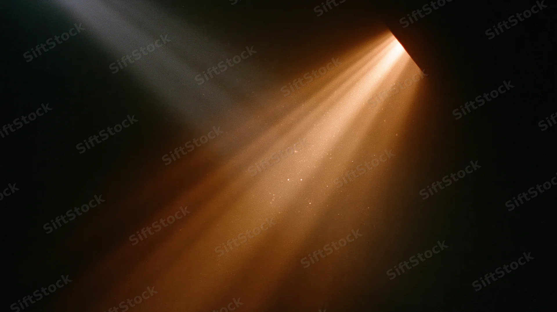 Golden sunlight streaming through a narrow opening into a dark space, illuminating floating dust particles