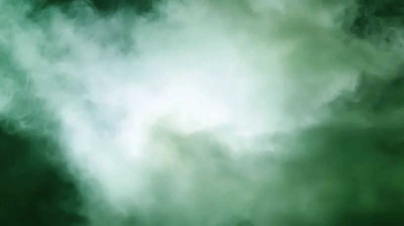 Swirling green smoke forming a soft abstract cloud with central brightness and diffuse edges