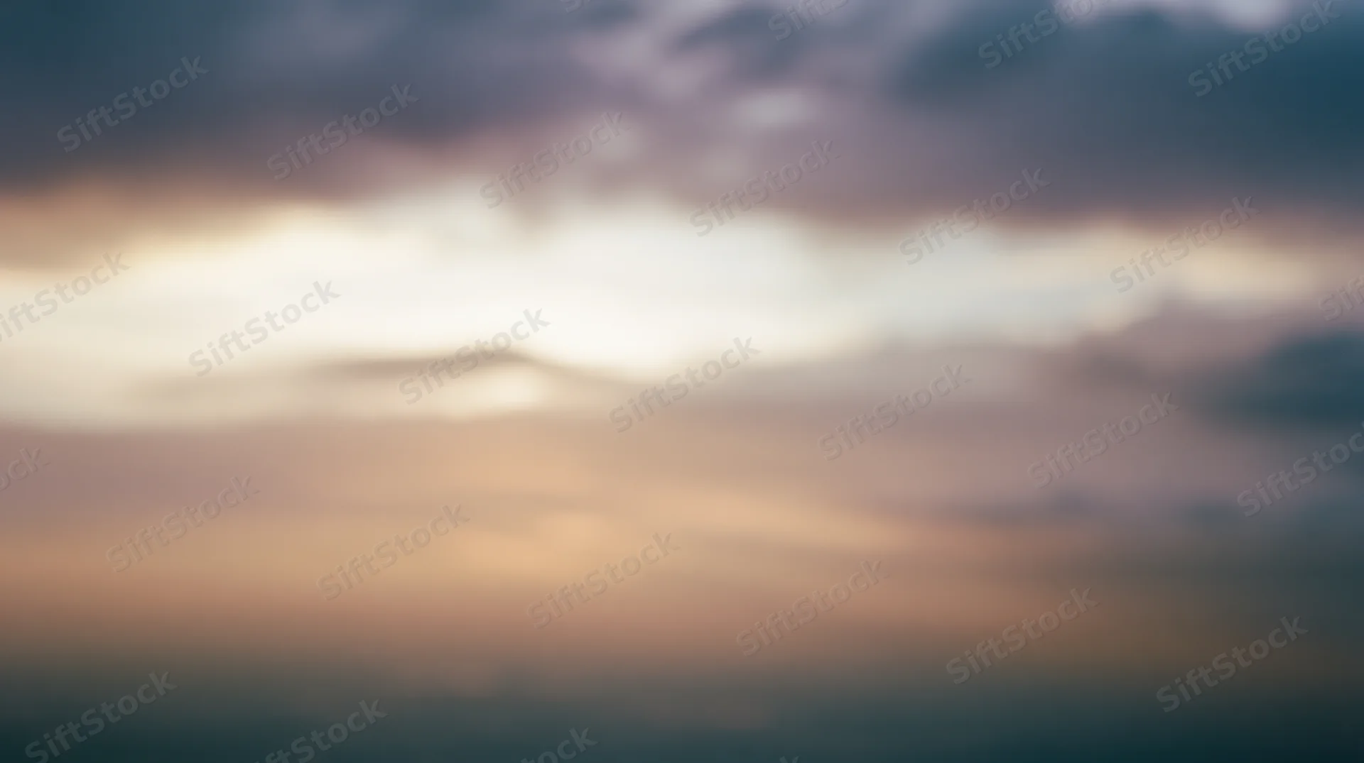 Soft pastel sky with blurred clouds at twilight horizon