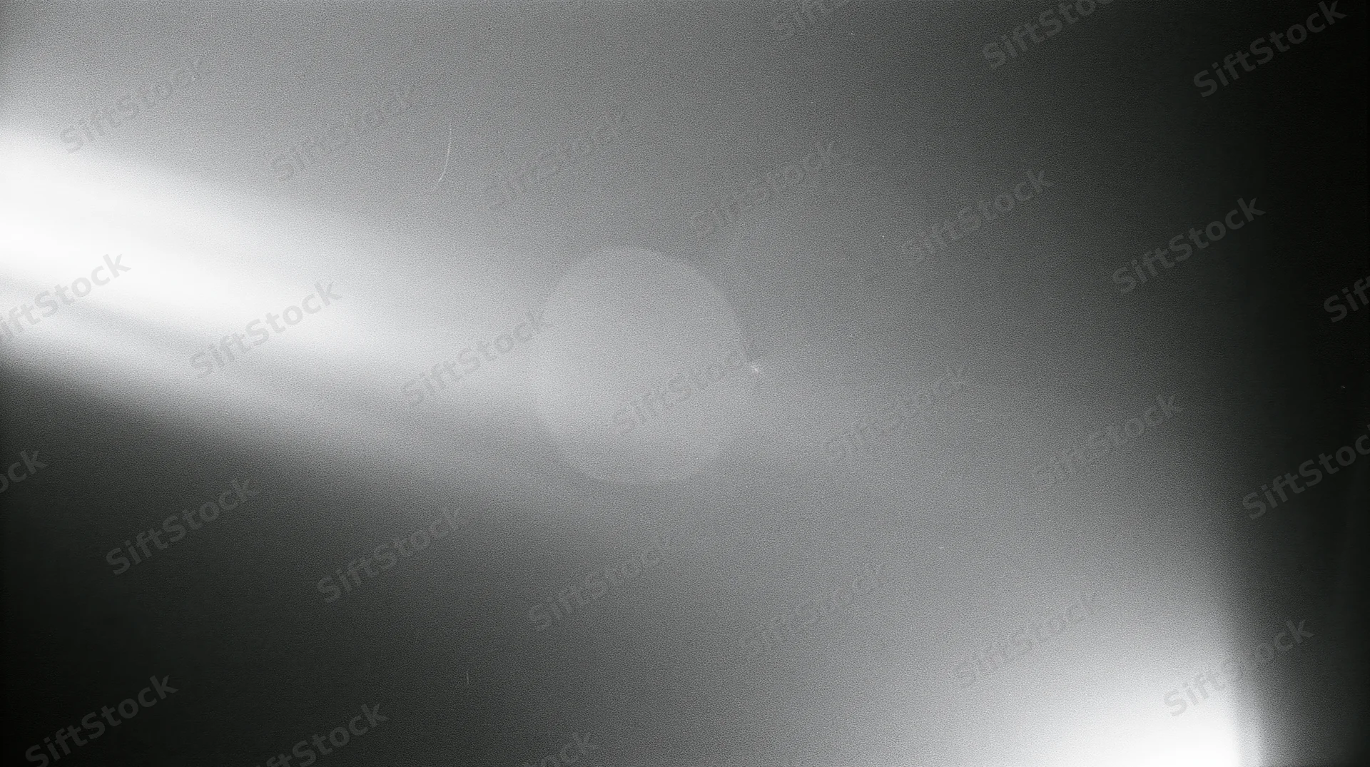 Bright light flare with soft glow and gradient in monochrome abstract view