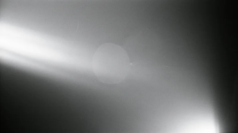 Bright light flare with soft glow and gradient in monochrome abstract view