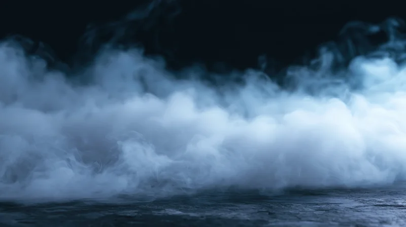 Swirling smoke rising from dark ground at night
